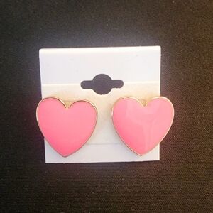 Pink heart-shaped earrings.